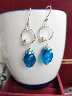 These are a pair of my favorite earrings. Sterling Silver ear wires, cornflower blue glass beads, and large silver jumprings with metallic silver acrylic bead accents. Just another project leaving me wishing I had more of these cute and lovely blue glass beads. As usual for me, I have had the beads in my inventory for so long that I don't even recall where I purchased them. More than likely from Ben Franklin Crafts (I love that store). Though simple in design, these earrings are surprisingly sop Nickel-free Blue Beaded Sterling Silver Earrings, Blue Wire-wrapped Glass Earrings, Blue Glass Wire Wrapped Earrings, Blue Wire Wrapped Glass Earrings, Blue Sterling Silver Wire Wrapped Beaded Earrings, Blue Wire Wrapped Sterling Silver Beaded Earrings, Blue Czech Glass Beaded Earrings Wire Wrapped, Blue Czech Glass Wire Wrapped Beaded Earrings, Blue Silver-plated Wire Earrings