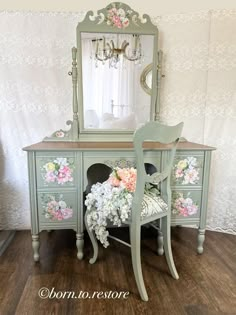 an antique desk with flowers on it and a mirror