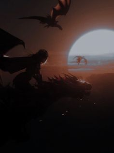 two dragon like creatures flying in front of the sun