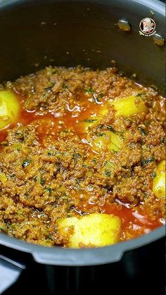 a pot filled with meat and vegetables on top of a stove