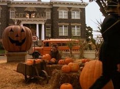 pumpkins and hay in front of an old building