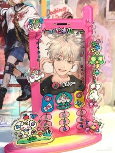 a pink cell phone with an anime character on it's display case next to other items