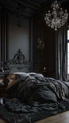 an unmade bed in a dark room with chandelier