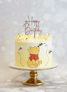 a winnie the pooh birthday cake with white frosting