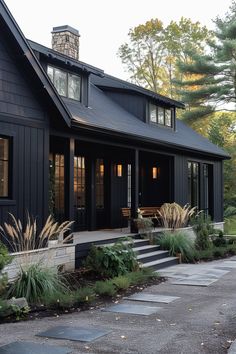 a black house with steps leading up to the front door