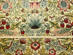 an intricately designed piece of cloth with birds and flowers on the front, in yellow