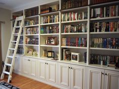 a ladder is in front of a bookshelf with many books on the shelves