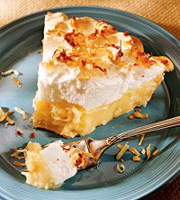 a piece of pie on a blue plate with a fork and spoon next to it