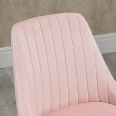 a pink chair sitting on top of a hard wood floor