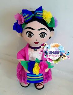 a stuffed doll that is wearing a colorful outfit