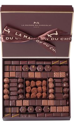 an assortment of chocolates in a box on a white background with the words,'du