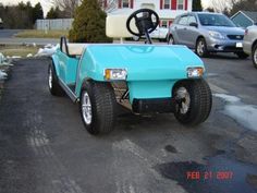 a blue golf cart parked in a parking lot