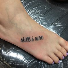 a foot with the word still i rise written on it