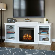 a tv mounted on the wall above a fireplace