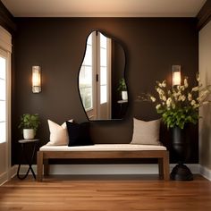 a living room with a bench, mirror and vase on the wall next to it