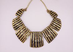 Very nice artisan made brass panel bib necklace. Seven graduated panels in gold tone brass with textured organic stripe pattern. Necklace is in very good vintage condition and hook clasp is in good working order. Adjustable length: 41 - 45 cm  Bib: 18 cm wide, 4 cm high IMPORTANT SHIPPING INFO: All shipping, including domestic, is standard with tracking. I generally ship on Monday and Thursday. If you need an item before a certain date please contact me before placing your order. Statement Jewellery, Bib Necklaces, Necklace Unique, Hook Clasp, Bib Necklace, Statement Jewelry, Vintage Brass, Stripes Pattern, Netherlands