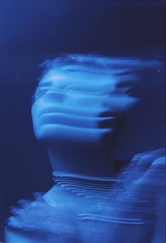 a blurry photo of a woman's face in blue