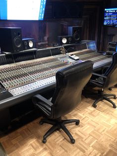 an empty recording studio with many sound equipment