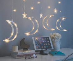 three stars and crescents are hanging from the ceiling above a desk with an ipad