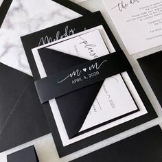 black and white wedding stationery with the bride's name printed on it, along with matching envelopes