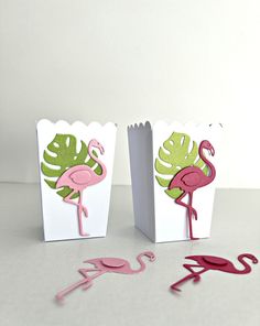 two paper bags with flamingos on them and one has a cutout of a leaf