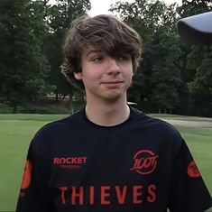 a young man standing in front of a frisbee