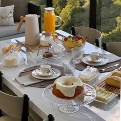 the table is set with desserts and drinks for two people to enjoy in the afternoon