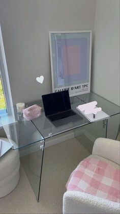 a glass desk with a laptop on it