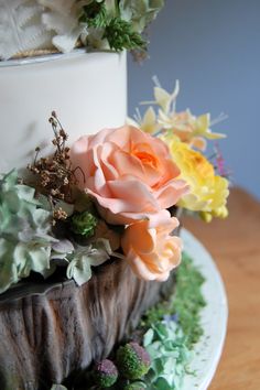 a three tiered cake with flowers on top