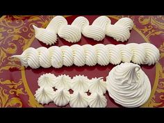 there are many different types of meringue on the red plate with gold trim