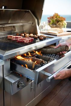 two people are cooking food on an outdoor grill