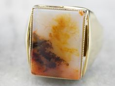 Wow, this is one stunning statement piece! This gorgeous stone is an agate, a milky stone with dandelion, cream, and burnt umber hues within its depths. Bezel set into a heavy yellow gold mounting, this piece is perfectly polished and ready to wear! Metal: 14K Yellow Gold Gem: Agate Gem Measurements: 18.2 x 13.4 mm, Rectangle Ring Size: 11.50 Marks: "585" Stamped on the inside band Yellow Gold Sapphire Ring, Rectangle Ring, Right Hand Ring, Burnt Umber, Gold Statement Ring, Cameo Ring, Right Hand Rings, Hand Ring, Cabochon Ring