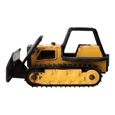 a yellow toy bulldozer sitting on top of a white surface