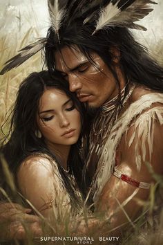 a man and woman are hugging in the grass with feathers on their head, one is wearing