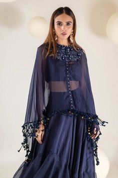 Nay blue cape with tonal, sequin, floral embroidered yoke and tassel danglers. Paired with an inner blouse and tiered skirt. - Aza Fashions Blue Sets With Sheer Dupatta And Cape Sleeves, Blue Party Sets With Cape Sleeves, Cape Skirt, Placement Embroidery, Blue Cape, Embroidery Floral, Tiered Skirt, Set For Women, Aza Fashion