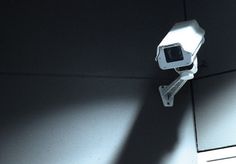 a security camera sitting on the side of a wall