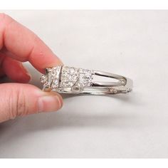 This is part of Chairish’s Costume Jewelry assortment.  1950s rhodium plated baguette and round clear rhinestone hinged cuff bracelet with security chain. Marked "Ledo" in script. Measures: 5/8 inches tall by 2 1/4 inches deep by 2 3/8 inches wide. Interior circumference is 6 1/4 inches without the hinges pulled out at all and can expand to about 7 inches. Excellent condition. Wedding White Gold Bangle, White Gold Metal Wedding Bangle, Silver Cuff Bracelet With Diamond Accents For Wedding, Formal Silver Bangle With Prong Setting, Elegant Rhinestone Bangle For Formal Occasions, Formal Silver Rhinestone Bangle, Formal Silver Bangle With Rhinestones, Silver Rhinestone Bangle For Formal Occasions, Silver Cubic Zirconia Cuff Bracelet For Anniversary