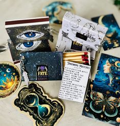 several cards and magnets on a table with an eye in the middle, surrounded by other items