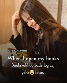 a woman with long hair sitting down reading a book