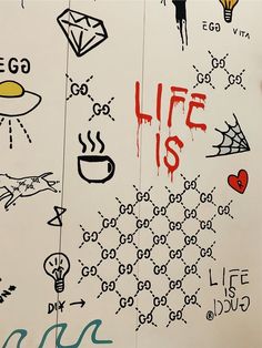 graffiti written on the side of a white board with words and symbols painted all over it