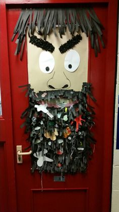 a door decorated with paper mache faces and hair