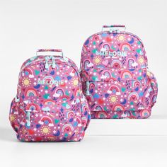 A backpack that's extra comfy and ready to handle daily adventures. A whimsical mix of raindrops, rainbows, stars and more shower the magenta exterior of our kids' large knapsack, and light aqua trim adds an extra burst of color. It's constructed of supremely durable polyester made from recycled water bottles and has a roomy interior to hold everything your kid needs—books, school supplies, extra layers. There's even a padded pocket to keep their tablet protected. Outside pockets hold snacks, wa