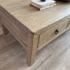 a coffee table with two drawers and a book on top