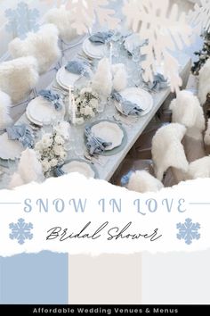 a snow themed table setting with white and blue decorations on it, surrounded by snowflakes