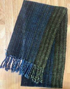 This is for you if you like dark blue and green. The one of a kind handwoven scarf is woven with quality rayon chenille yarns.  Finished size is 9.5"wide by 72" length (excludes fringes). The ends are finished with a 3.5" hand-knotted twisted fringe. Expertly woven by a lifelong weaver. I learned how to weave in college, apprenticed in France and Scotland, and have shown my work in major juried shows. I know you will enjoy wearing it as much as I enjoyed weaving it.  Therese Legere Weaver/Painter See my art at: legereart.com  Buy prints at: thereselegere.com Handwoven Chenille Scarf, Handwoven Rayon Chenille Scarf Blue, How To Weave, Handwoven Scarf, Buy Prints, Blue And Green, Clothing Items, Scotland, Hand Knotted