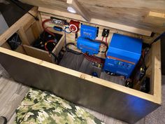 the inside of a wooden box with some electrical equipment in it