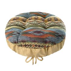 a multicolored round floor pillow with ties on the bottom and sides, sitting on a white background