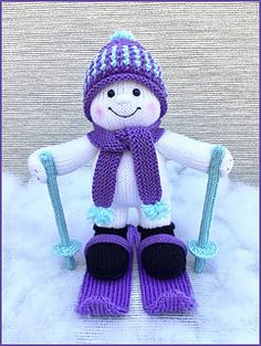 a knitted snowman doll with skis and hat