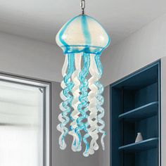 a blue and white jellyfish chandelier hanging from a ceiling in a bathroom