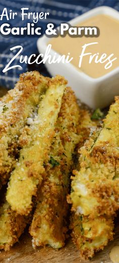 air fryer garlic and parm zucchini fries on a cutting board with dipping sauce